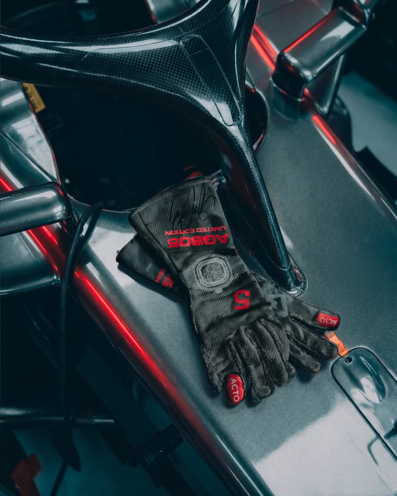 Racing gloves with AGB05 Limited Edition and the number 5, signed by Gabriel Bortoleto, on the car